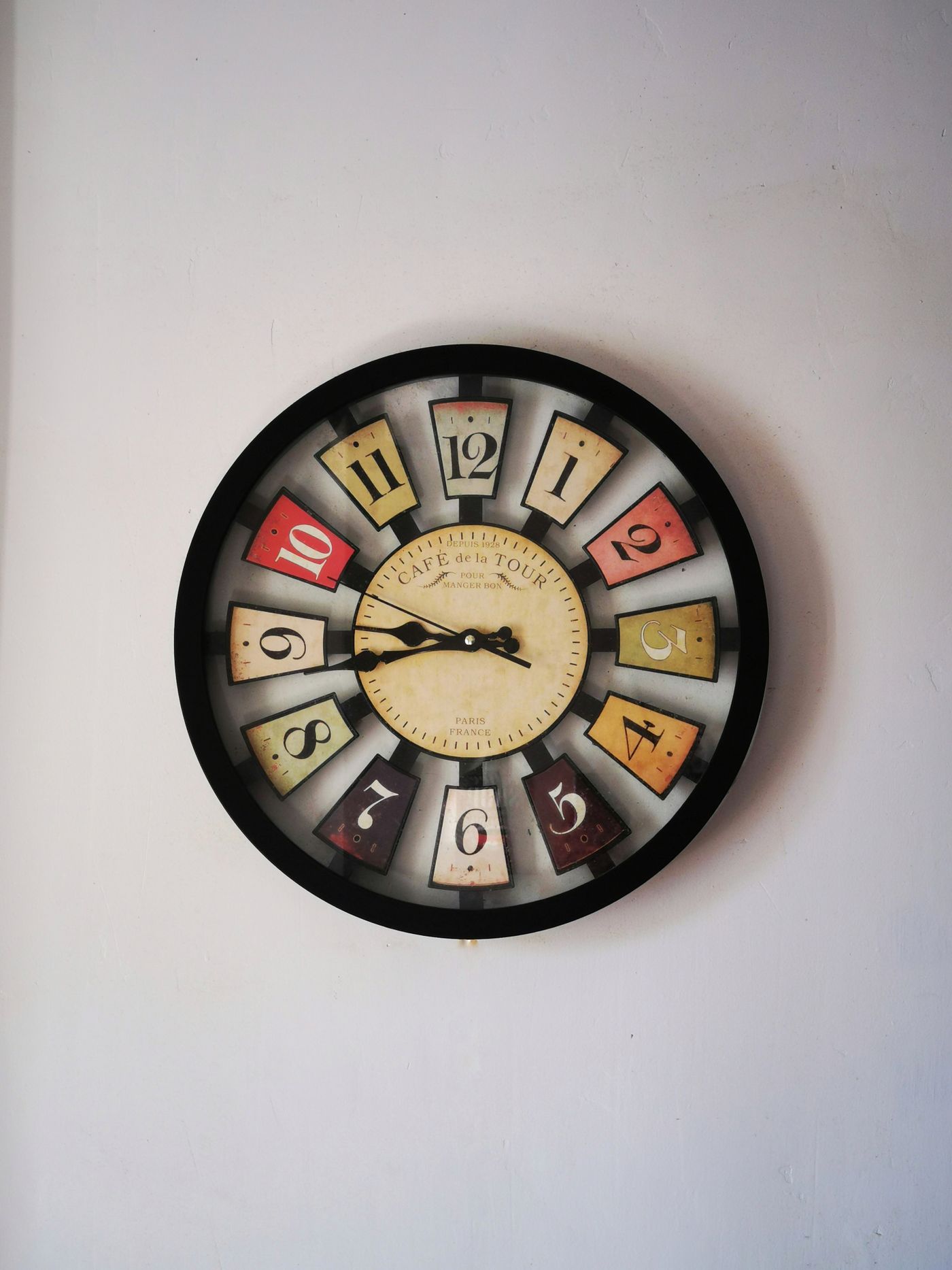 An ornate clock dial with multicoloured number panels