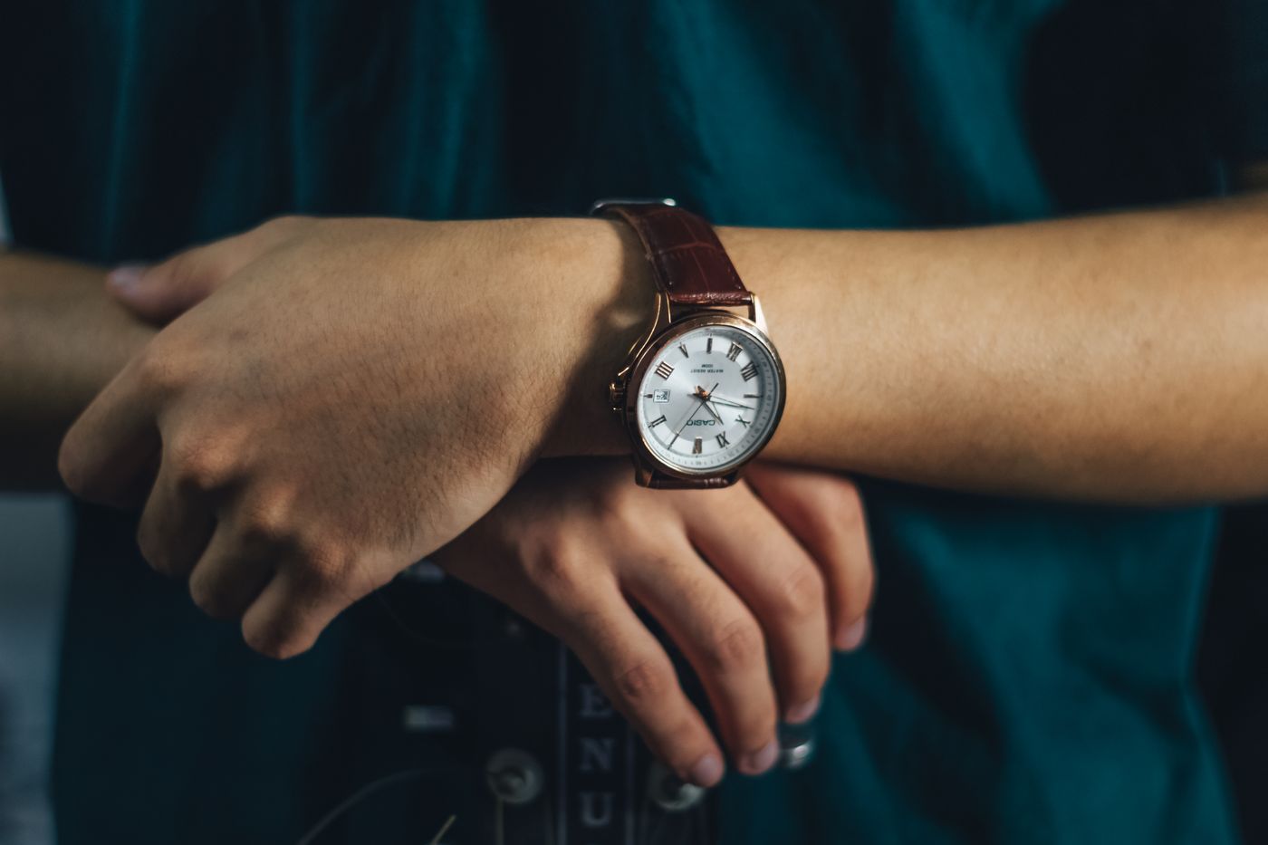 A leather-strapped wristwatch worn on the wrist